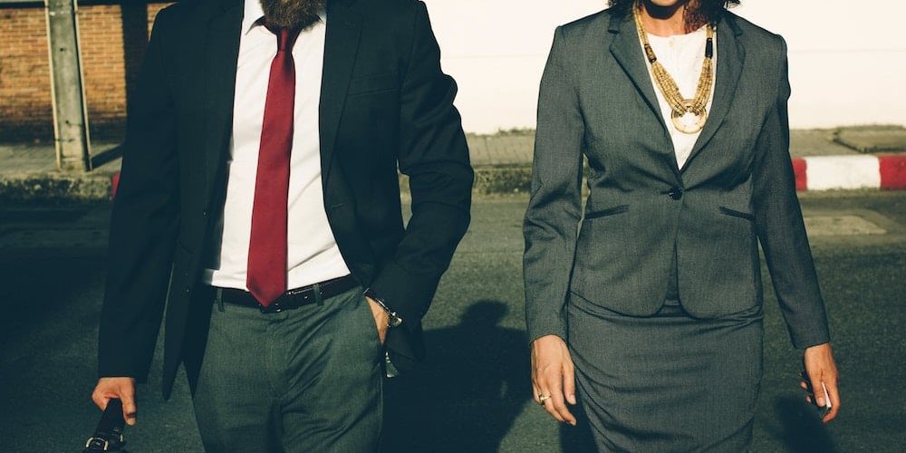 Photo of a man and woman in business attire
